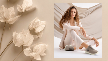Woman in a monochrome beige outfit wearing Merino Runners in reed, next to beige dried leaves on a light background.